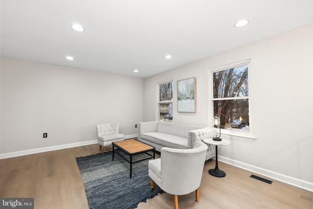 sitting room with recessed lighting, visible vents, baseboards, and wood finished floors