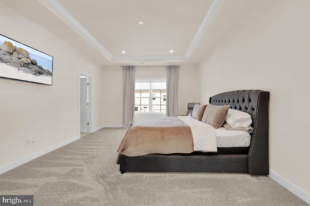 bedroom with light carpet, baseboards, a raised ceiling, and crown molding