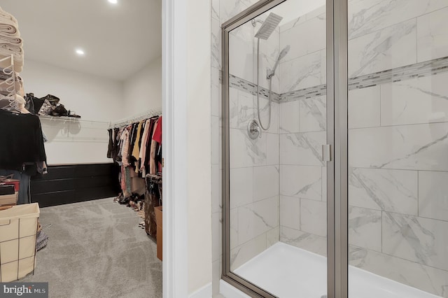 full bathroom with a stall shower, a walk in closet, and recessed lighting