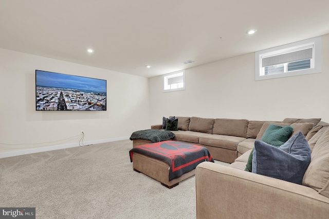 living room featuring recessed lighting, light colored carpet, visible vents, and baseboards