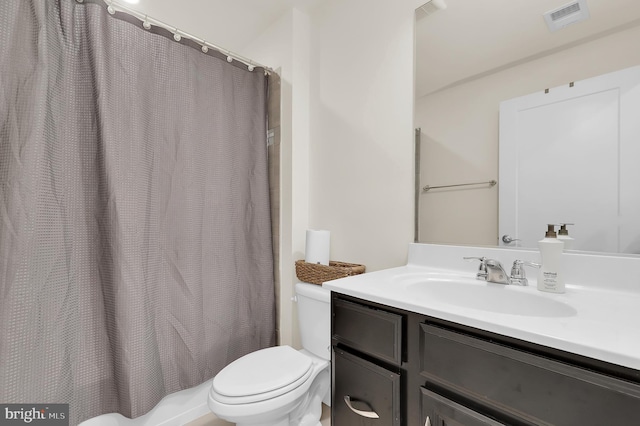 full bath featuring visible vents, vanity, and toilet