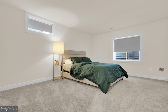 bedroom with carpet flooring and baseboards