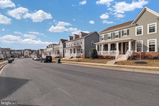 view of road featuring sidewalks, a residential view, and curbs