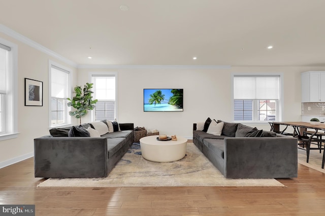 living room with ornamental molding, light wood-type flooring, recessed lighting, and baseboards