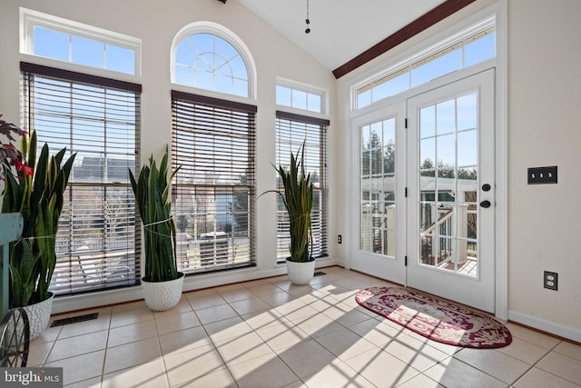 entryway featuring visible vents, baseboards, high vaulted ceiling, and tile patterned flooring