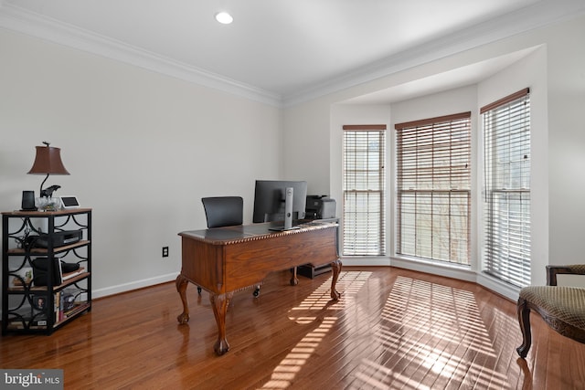 office space with baseboards, wood finished floors, and ornamental molding