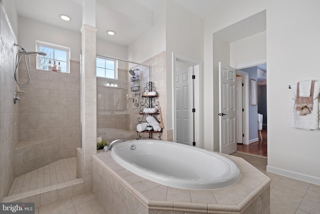 full bathroom featuring tile patterned flooring, tiled shower, a garden tub, and decorative columns