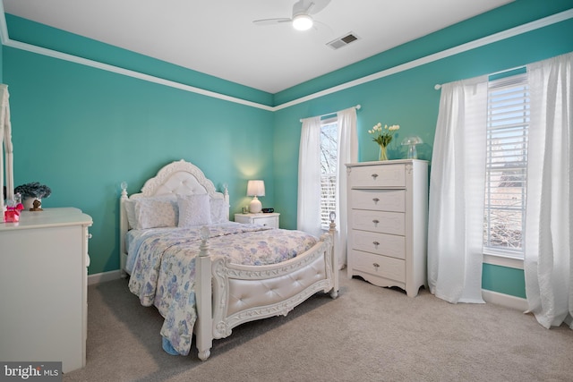 carpeted bedroom featuring visible vents, baseboards, and a ceiling fan