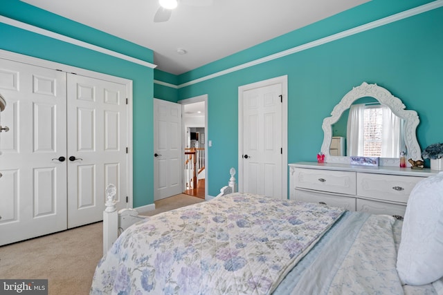 carpeted bedroom featuring a closet and ceiling fan