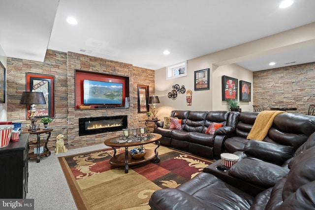 living room with recessed lighting, a stone fireplace, and carpet flooring