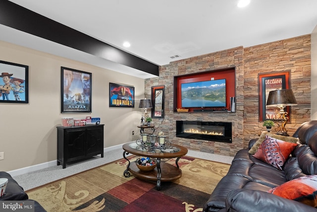 carpeted living area featuring recessed lighting, visible vents, baseboards, and a stone fireplace