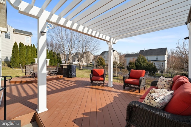 wooden deck featuring outdoor dining area, fence, and a pergola