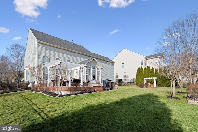 rear view of property with a yard, fence, a pergola, and a wooden deck