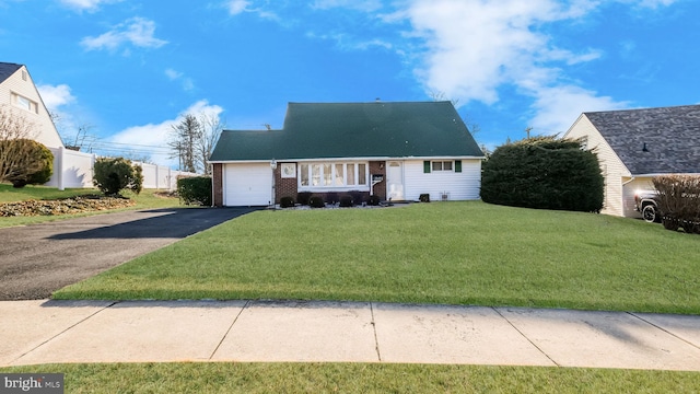 view of front of property featuring a garage and a front lawn