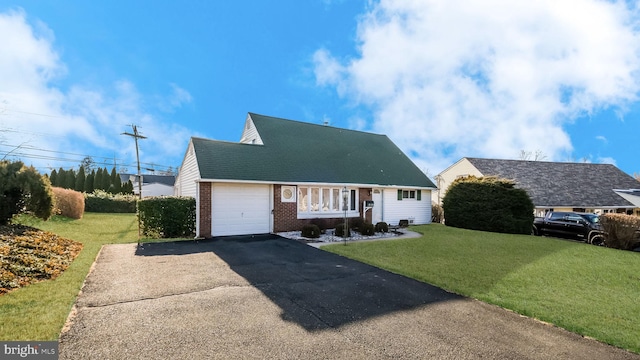 cape cod-style house featuring a garage and a front lawn