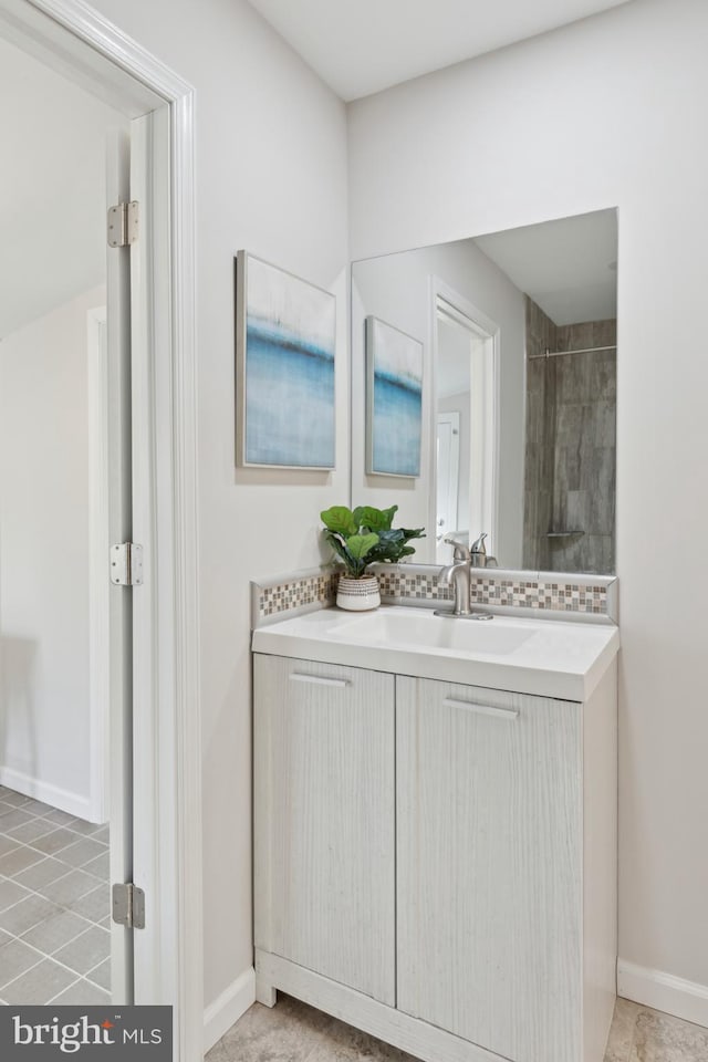 bathroom with vanity and tiled shower