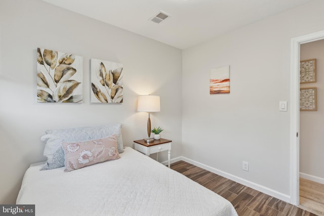 bedroom with hardwood / wood-style floors