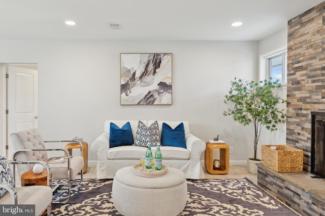 living room with a brick fireplace