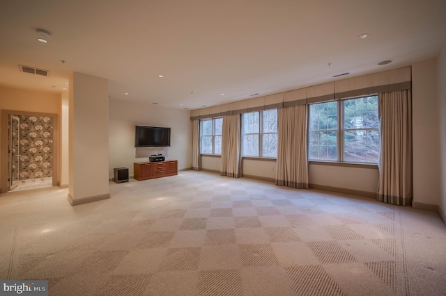 unfurnished living room featuring light colored carpet