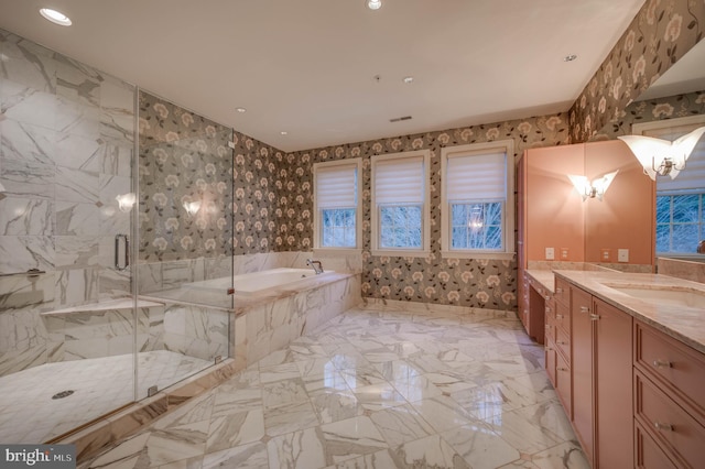 bathroom with vanity and separate shower and tub