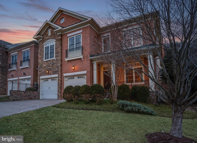 view of front of house featuring a garage and a lawn