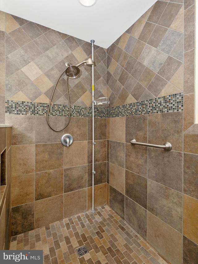 bathroom with a tile shower