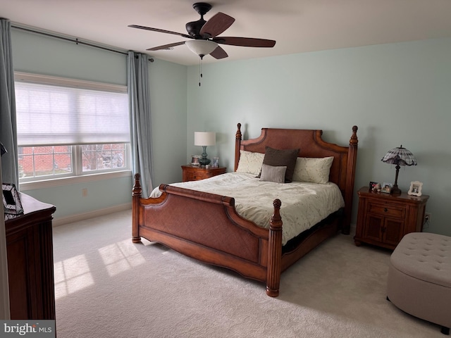 bedroom featuring light colored carpet and ceiling fan