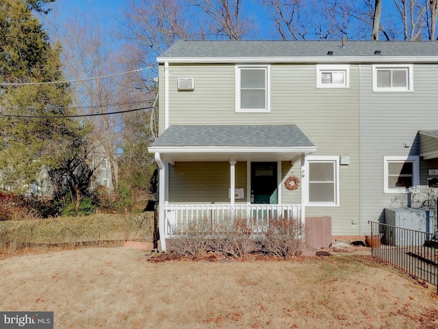 view of front of house featuring covered porch and a front lawn