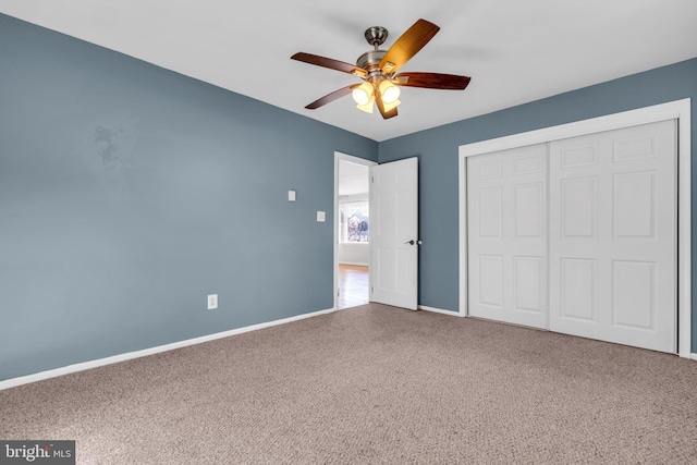 unfurnished bedroom with ceiling fan, carpet floors, and a closet