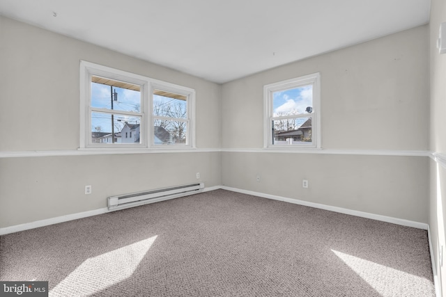 unfurnished room with carpet, a baseboard heating unit, and a healthy amount of sunlight