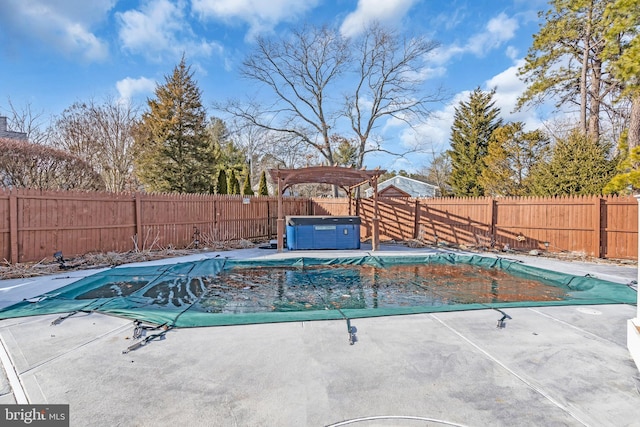 view of swimming pool with a hot tub and a patio area