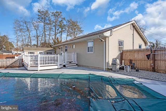 back of property with a swimming pool side deck