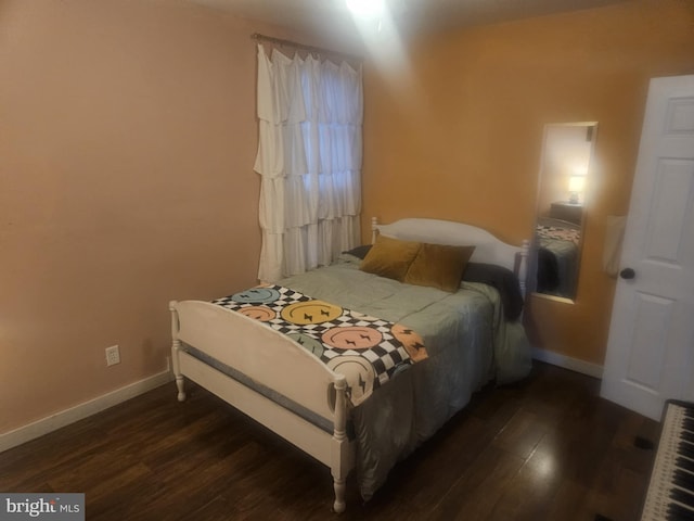 bedroom featuring dark hardwood / wood-style flooring