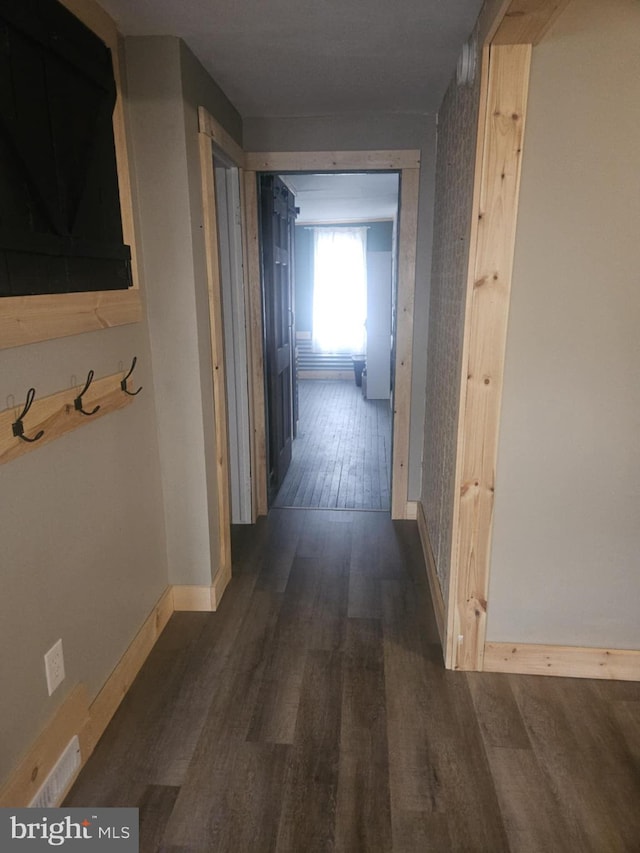 corridor featuring dark wood-type flooring