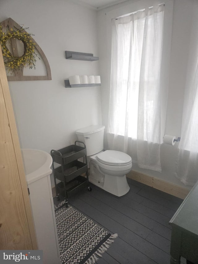 full bathroom featuring vanity, hardwood / wood-style flooring, bathing tub / shower combination, and toilet