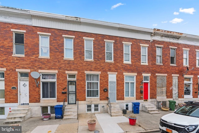 view of front of home featuring entry steps and brick siding