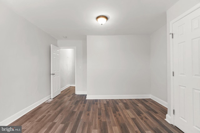 interior space with dark wood-style floors and baseboards