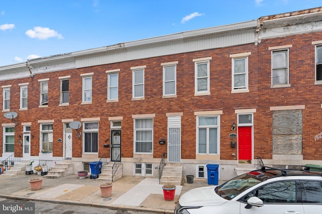 view of front of house featuring entry steps and brick siding