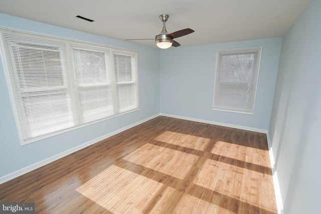 empty room featuring wood-type flooring and ceiling fan