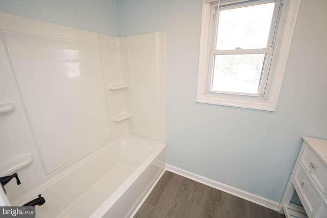 bathroom featuring shower / washtub combination, hardwood / wood-style floors, and vanity