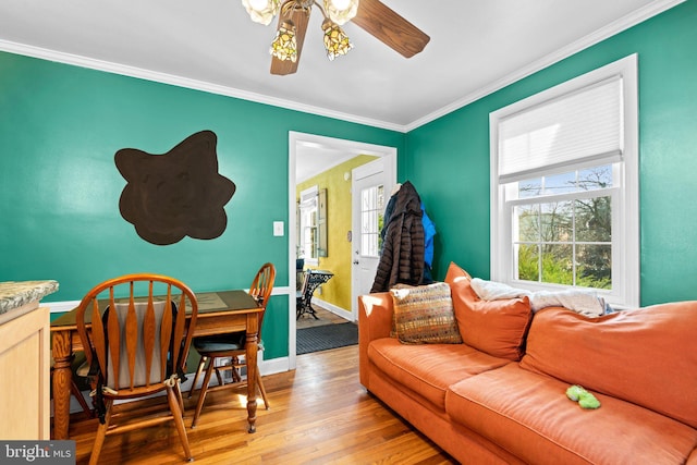 living room with crown molding, ceiling fan, and hardwood / wood-style floors