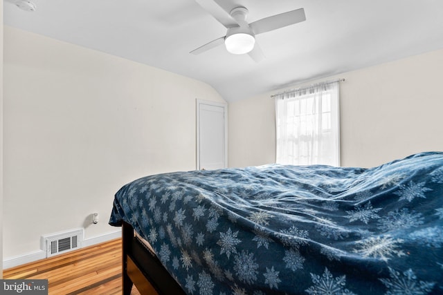 bedroom featuring vaulted ceiling, hardwood / wood-style floors, and ceiling fan