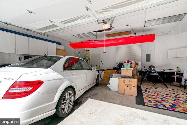 garage featuring a garage door opener and electric panel