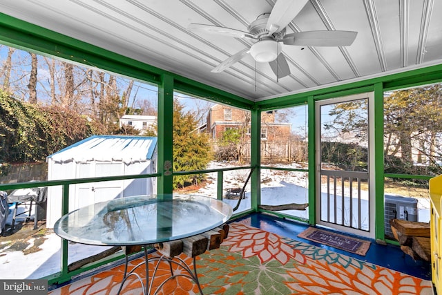 sunroom / solarium featuring plenty of natural light and ceiling fan