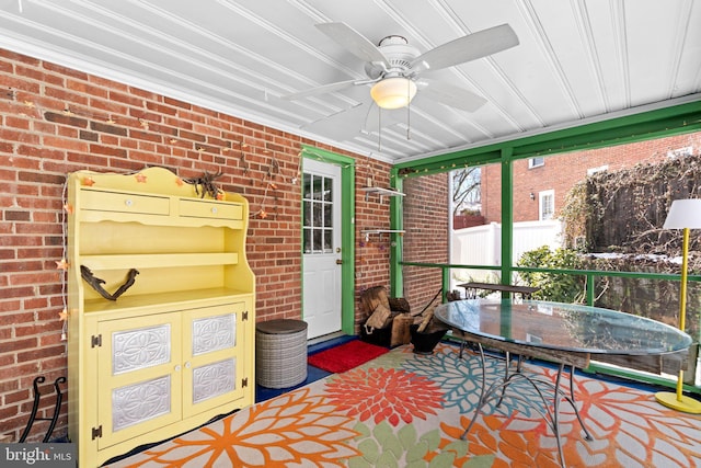 sunroom featuring ceiling fan