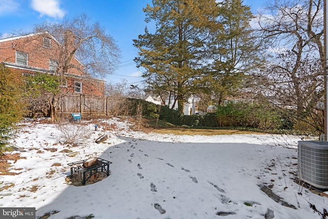 snowy yard with central AC unit