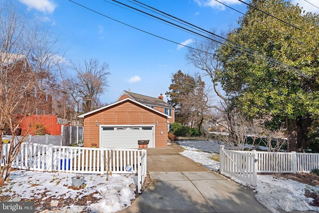 view of side of home featuring an outbuilding and a garage