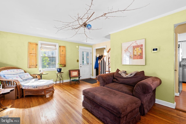 living room featuring ornamental molding and wood-type flooring