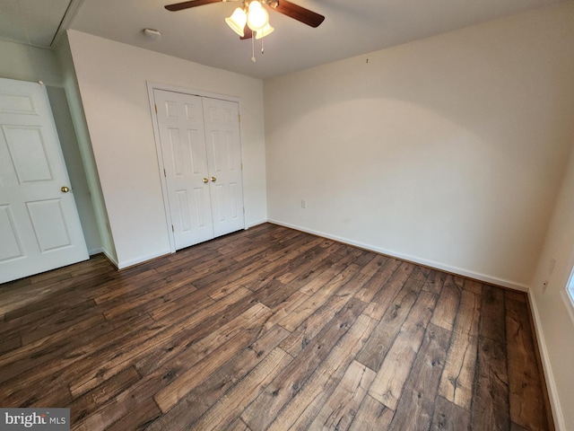 unfurnished bedroom with dark hardwood / wood-style flooring, ceiling fan, and a closet