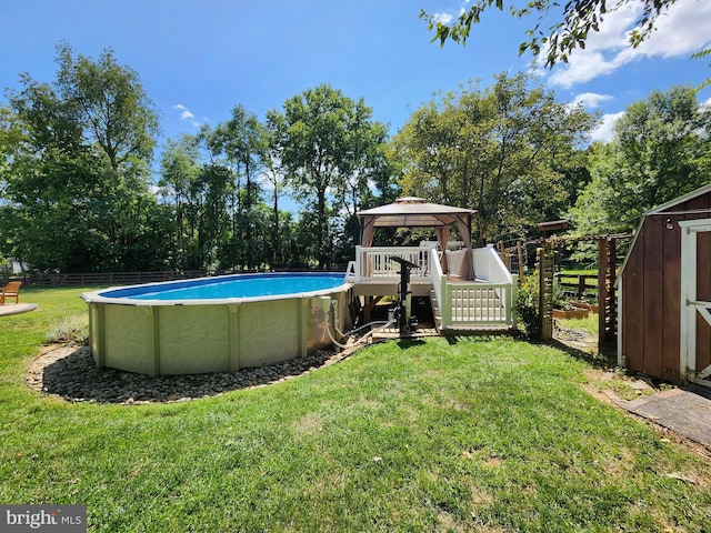 view of pool with a lawn, a storage shed, and a gazebo